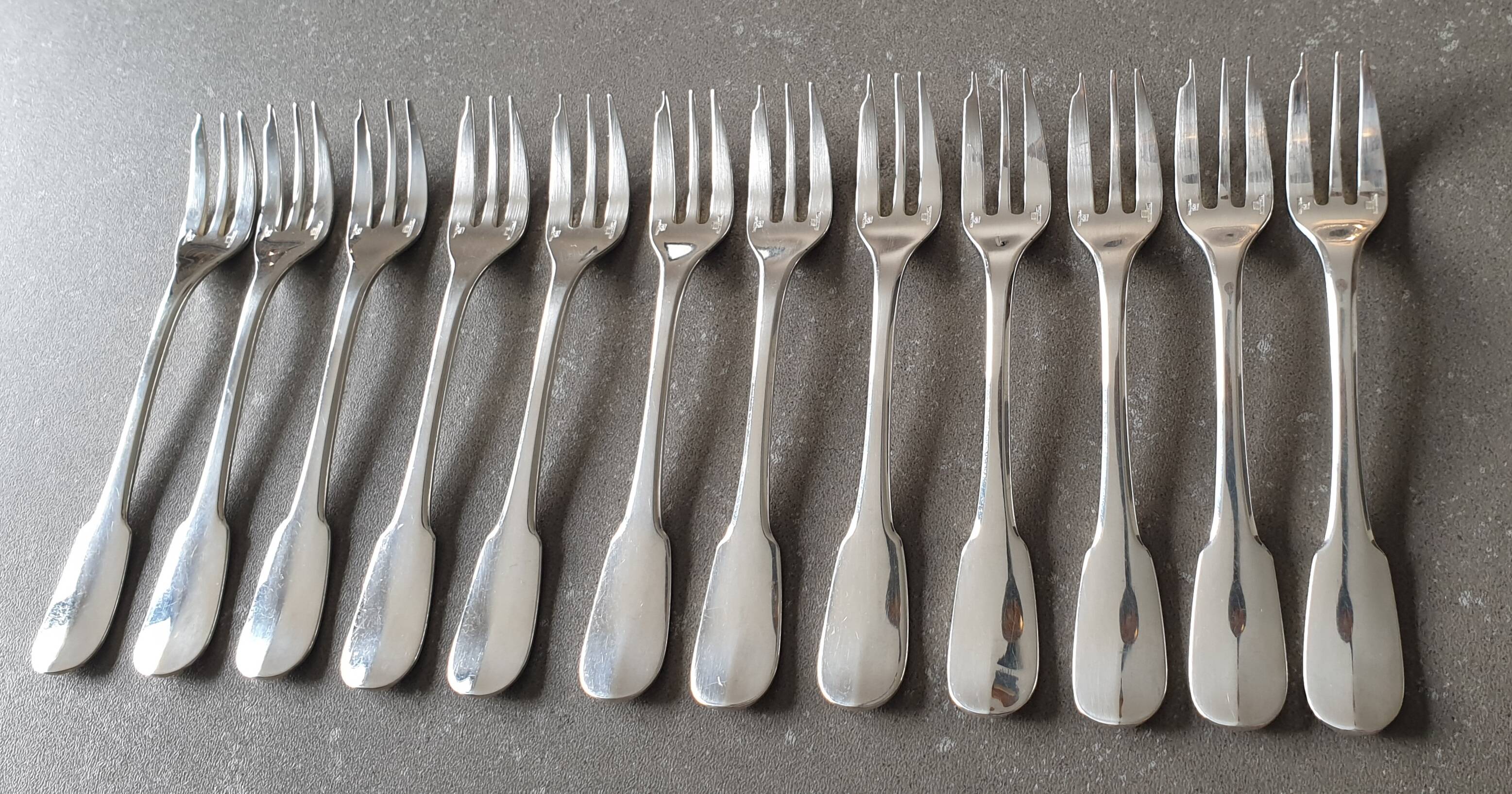 Set of 12 dessert forks and a cake server.