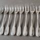 Set of 12 dessert forks and a cake server.
