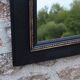 Vintage black and gold wooden mirror with a pediment – Napoléon III style