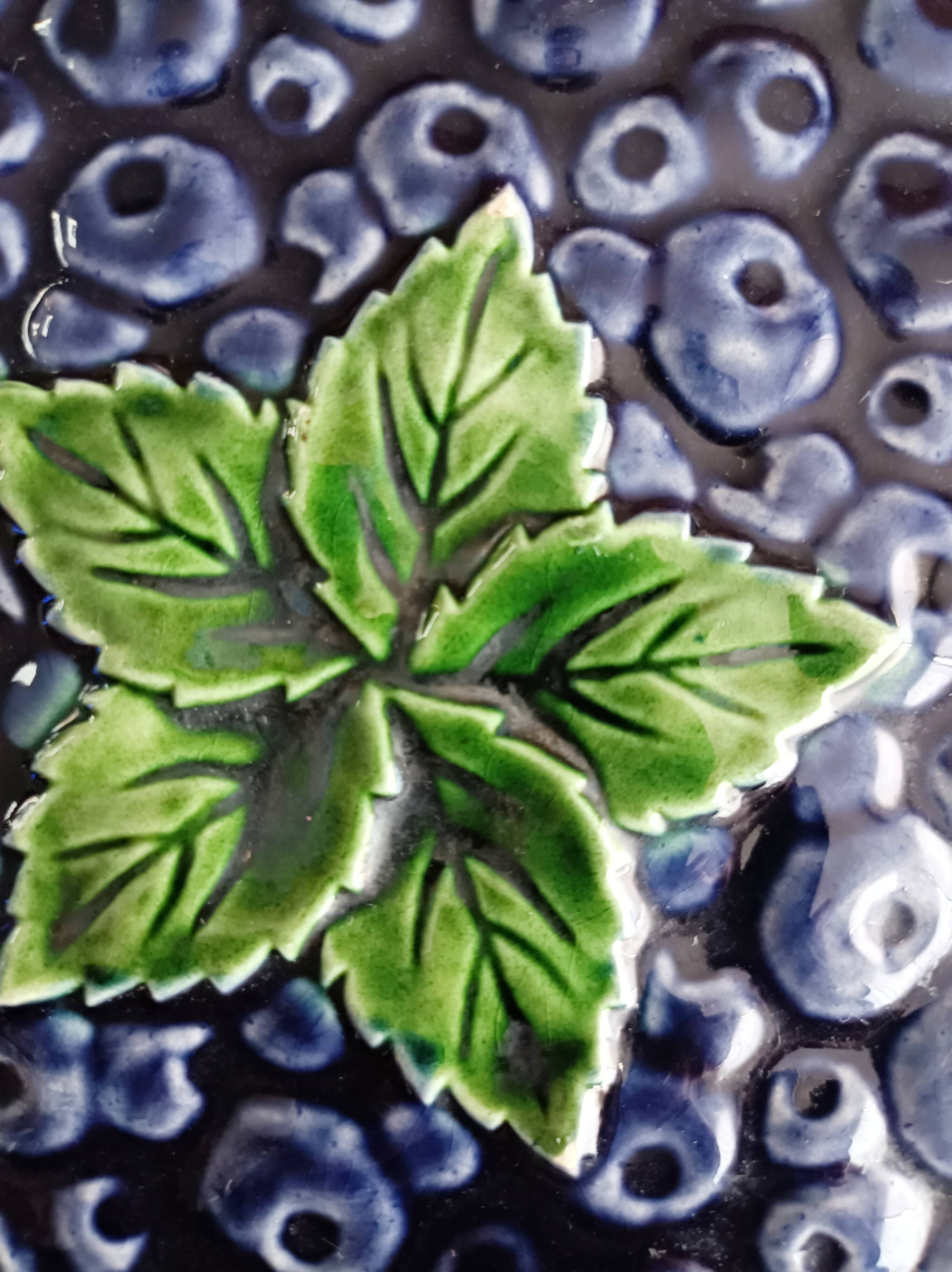 Pie dish on foot, in slip with blackberry decoration
