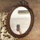 Miroir ovale mercure en bois sculpté décor nœud ruban 37X52