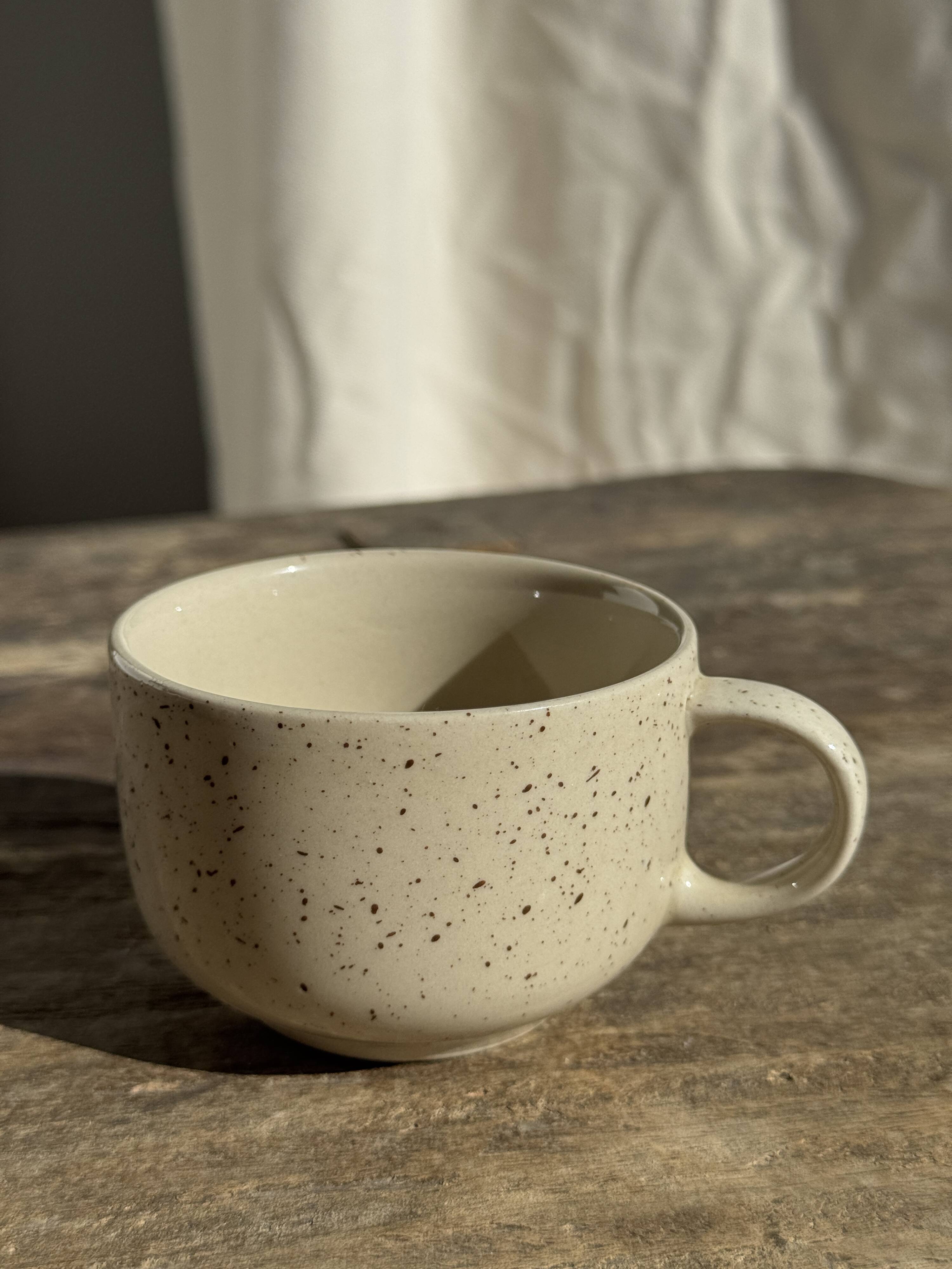 Set of 4 vintage speckled beige stoneware coffee cups.