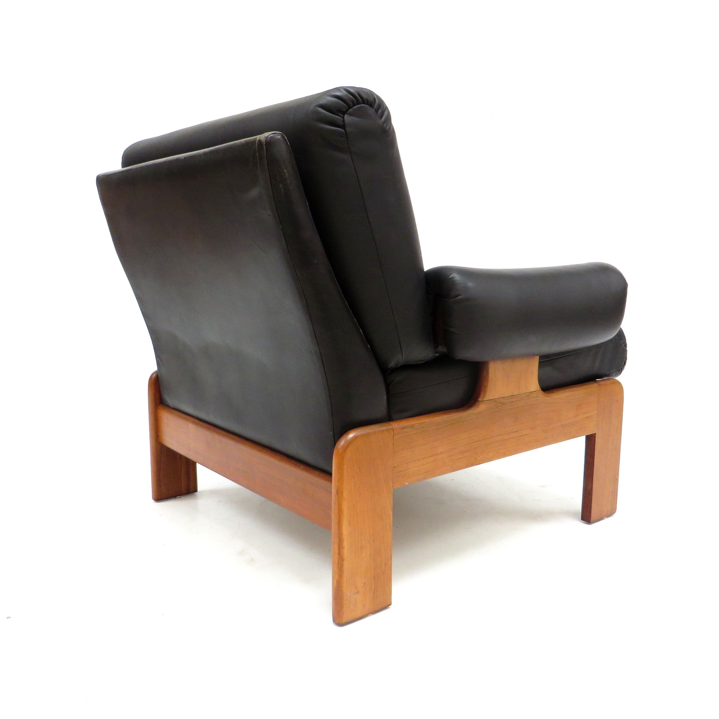 Vintage black leather armchair with solid rosewood frame made in the 1960s