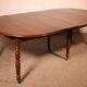 Extensible dining table from the early 19th century in walnut.