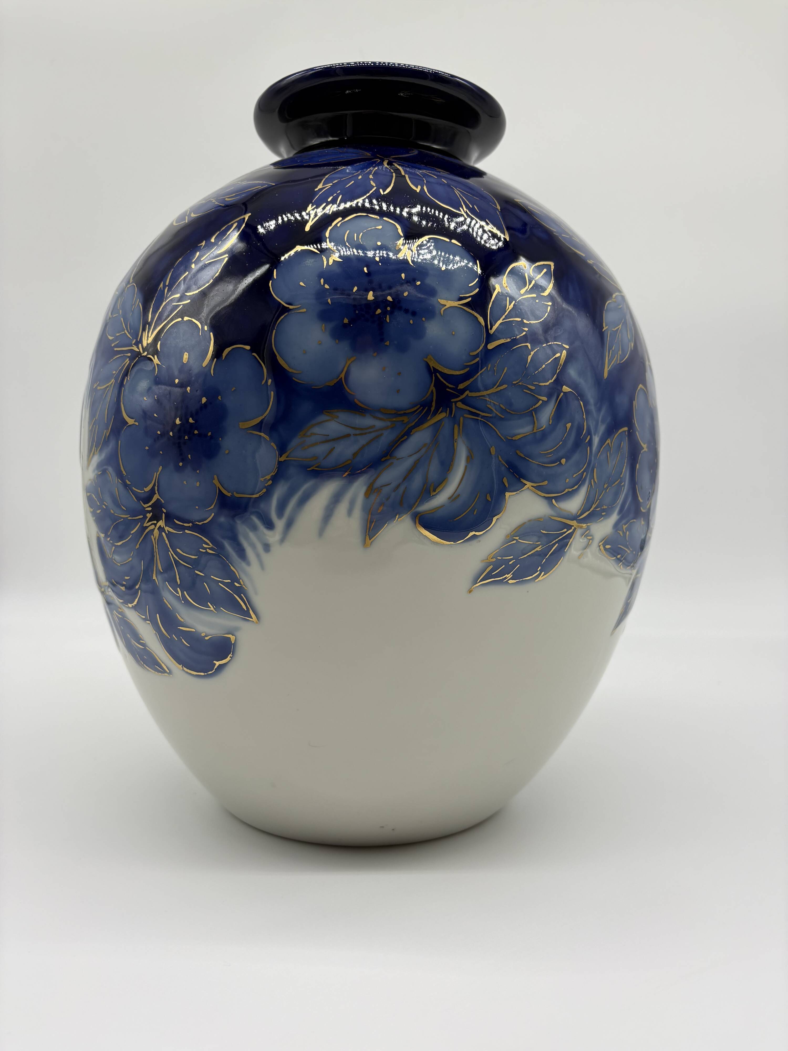 Large Tharaud Limoges vase in cobalt blue porcelain with floral decoration.