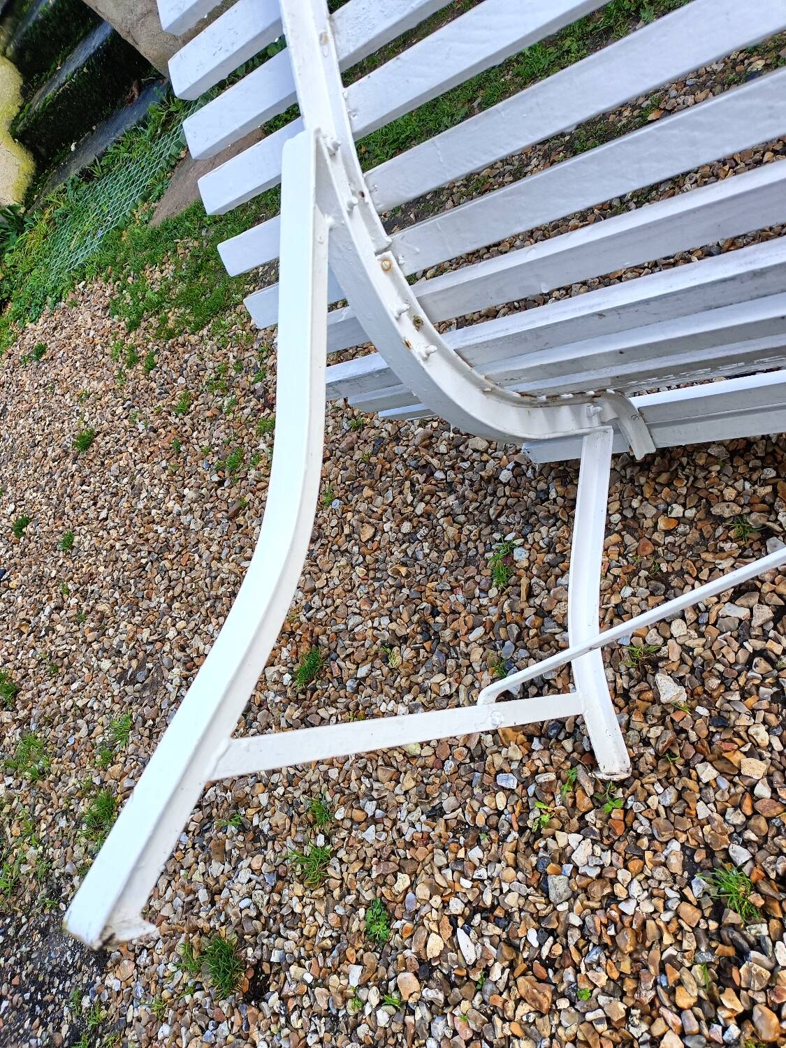 Old garden bench with metal legs and wooden slats