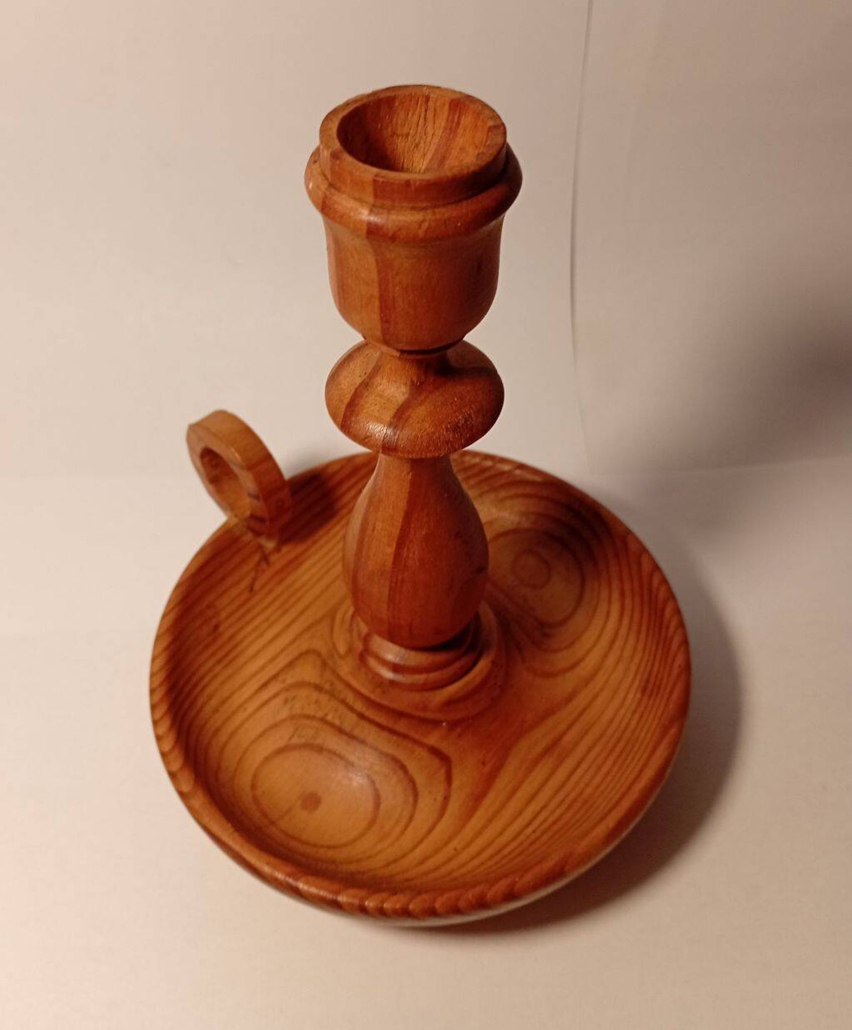 Vintage candlestick holder crafted from turned pine wood Scandinavian-style