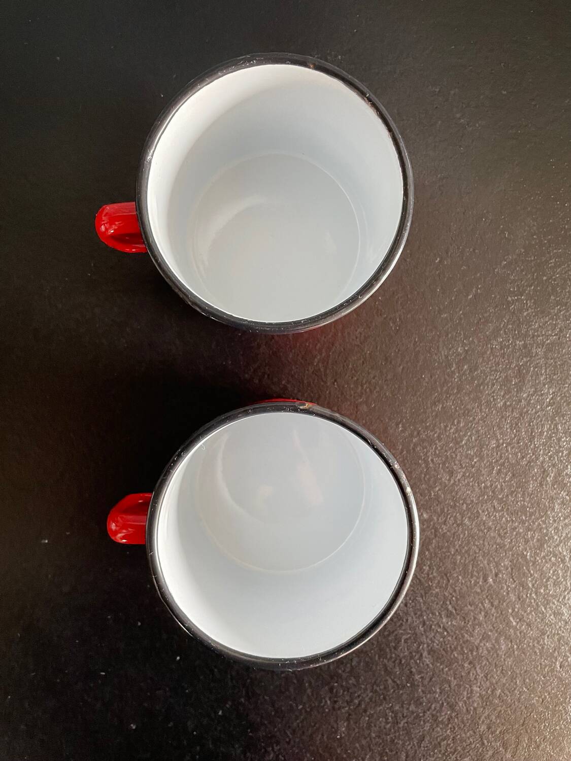 Red enameled sheet metal mug