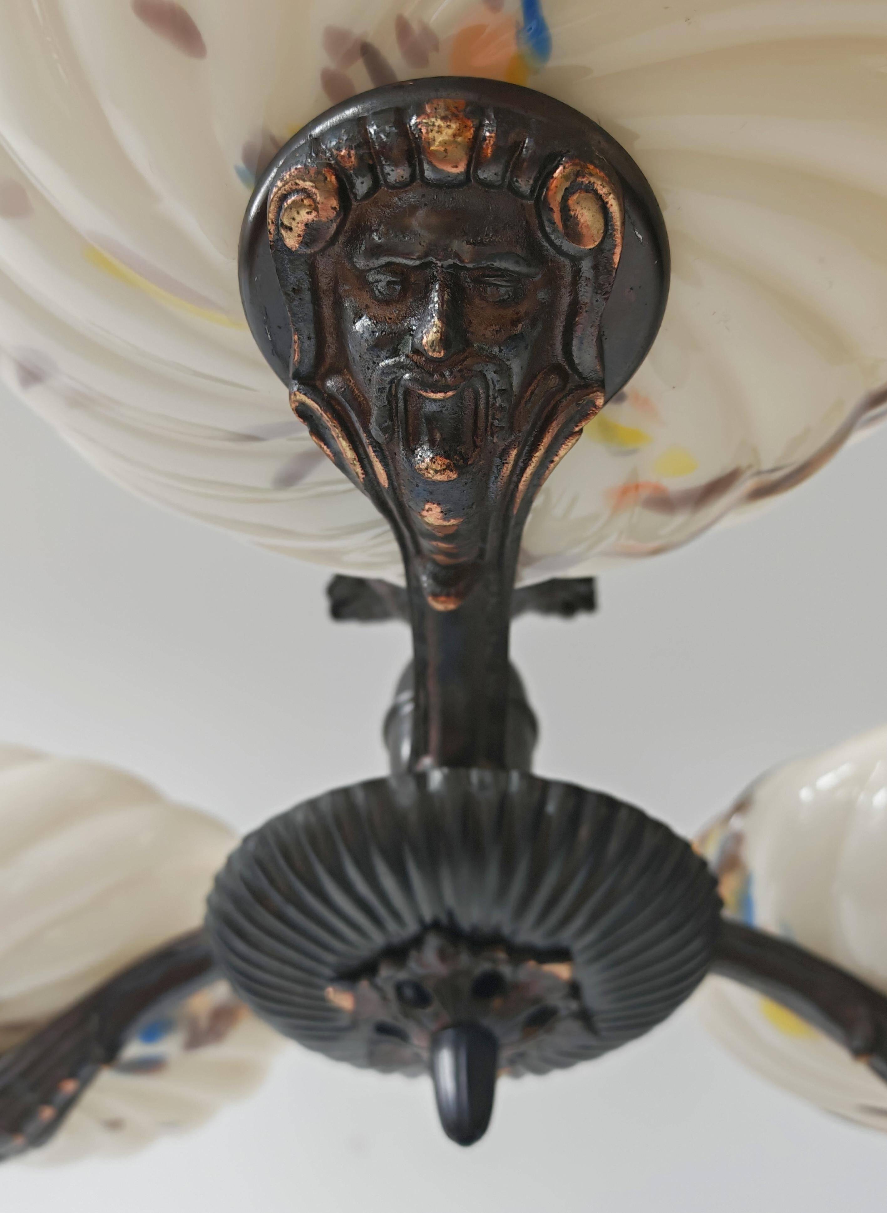 Art Deco bronze three-arm chandelier with marbled glass shades.
