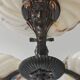 Art Deco bronze three-arm chandelier with marbled glass shades.