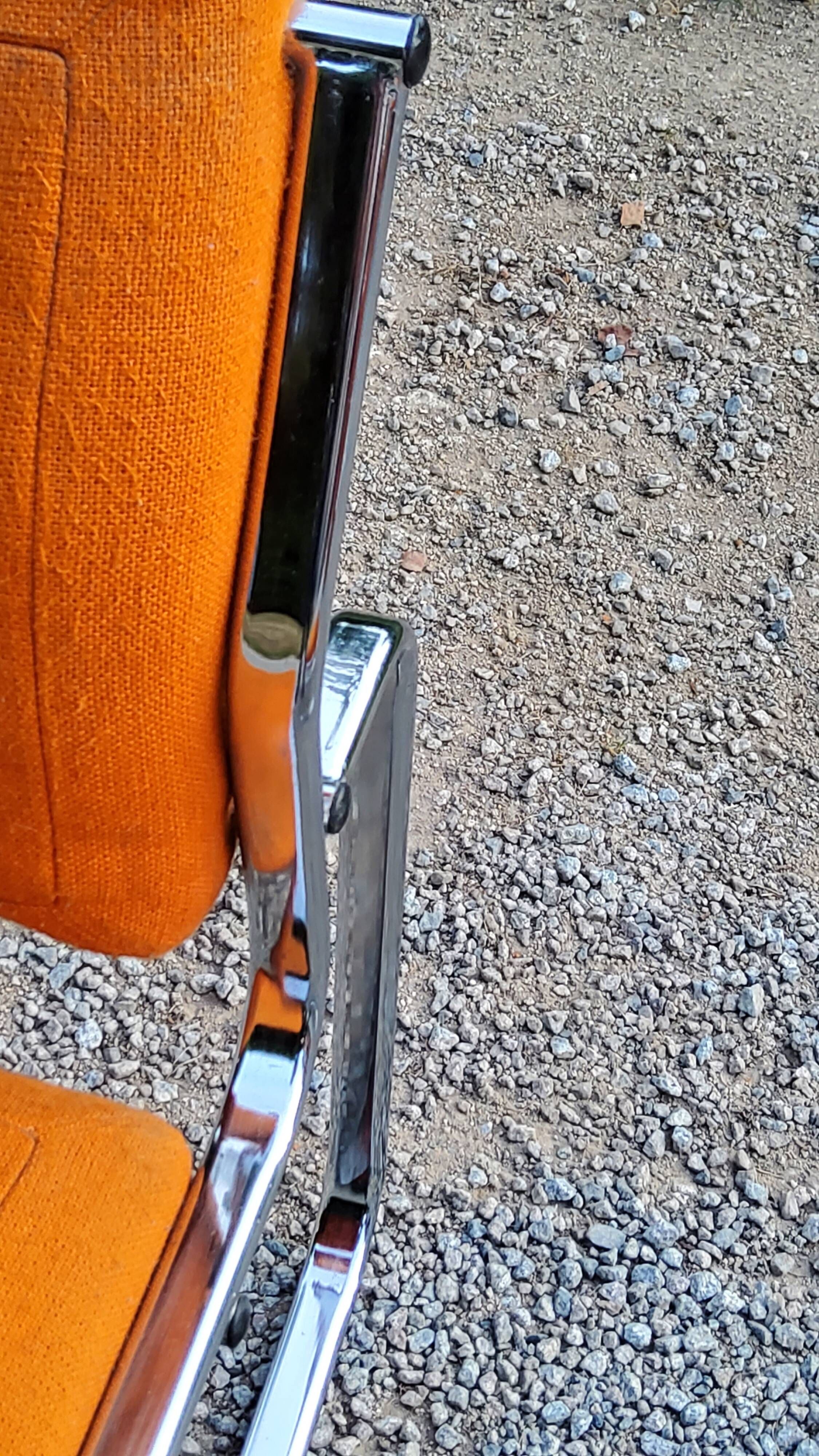 Pair of designer armchairs in orange fabrics and chrome tubes from the 70s