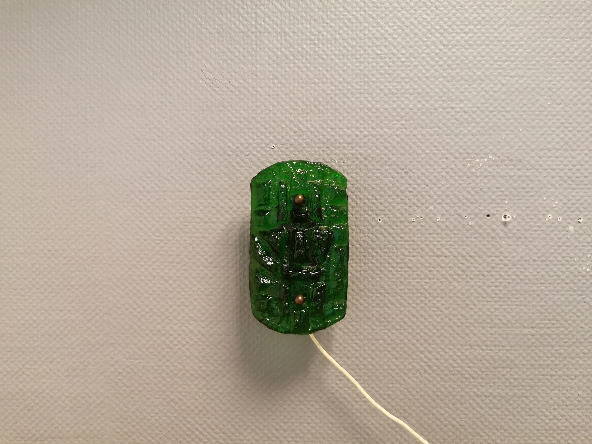 Old wall lamp made of hard pressed green glass.