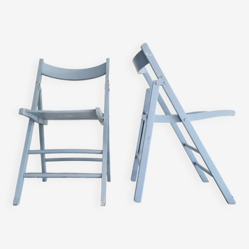 Pairs of old blue folding chairs