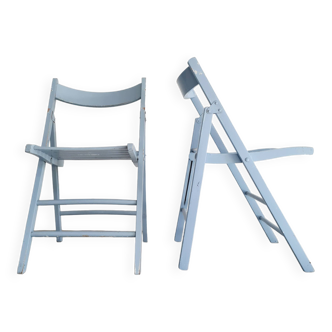 Pairs of old blue folding chairs