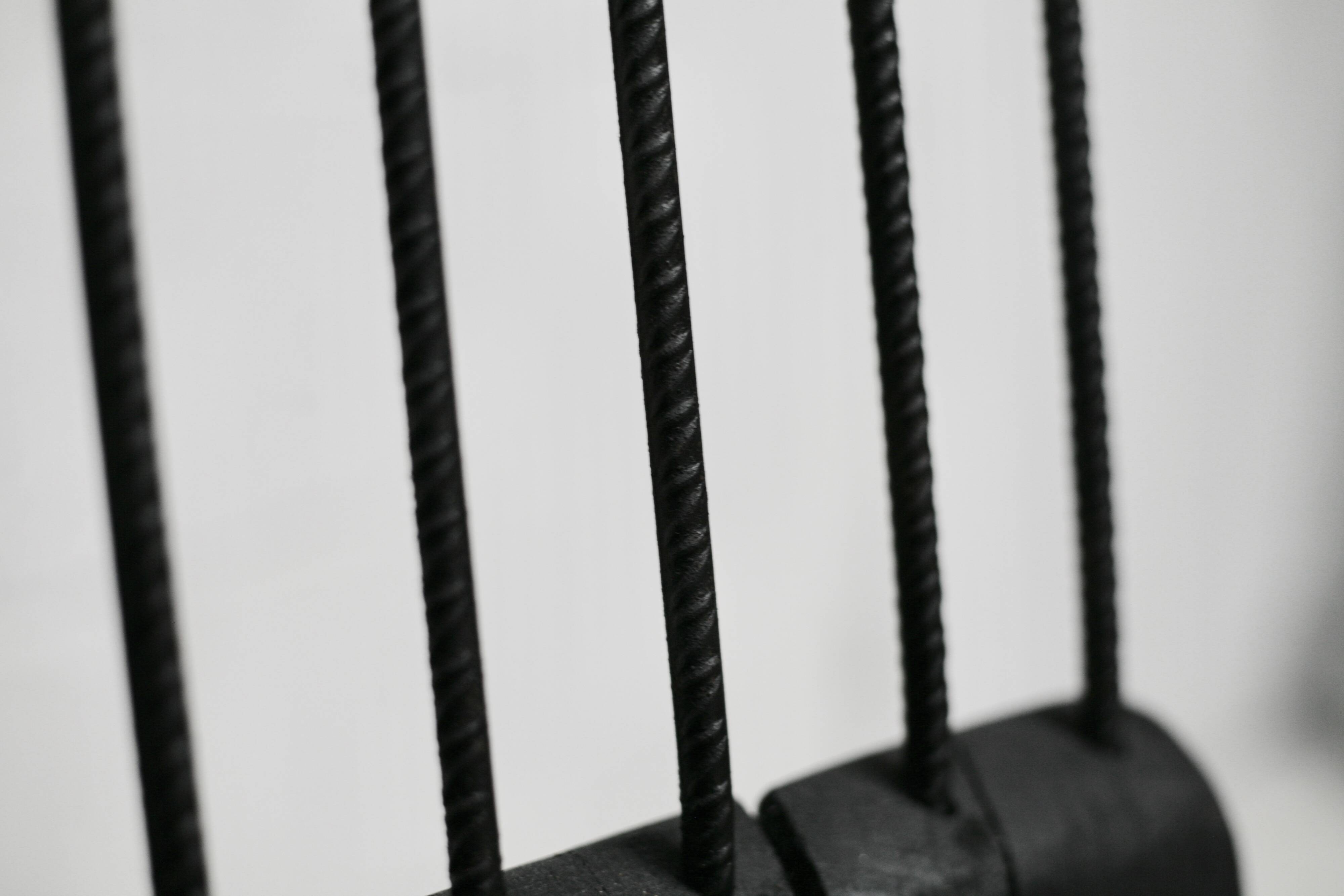 Brutalist chair, black-stained raw wood, steel. Work from the 1970s