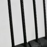 Brutalist chair, black-stained raw wood, steel. Work from the 1970s