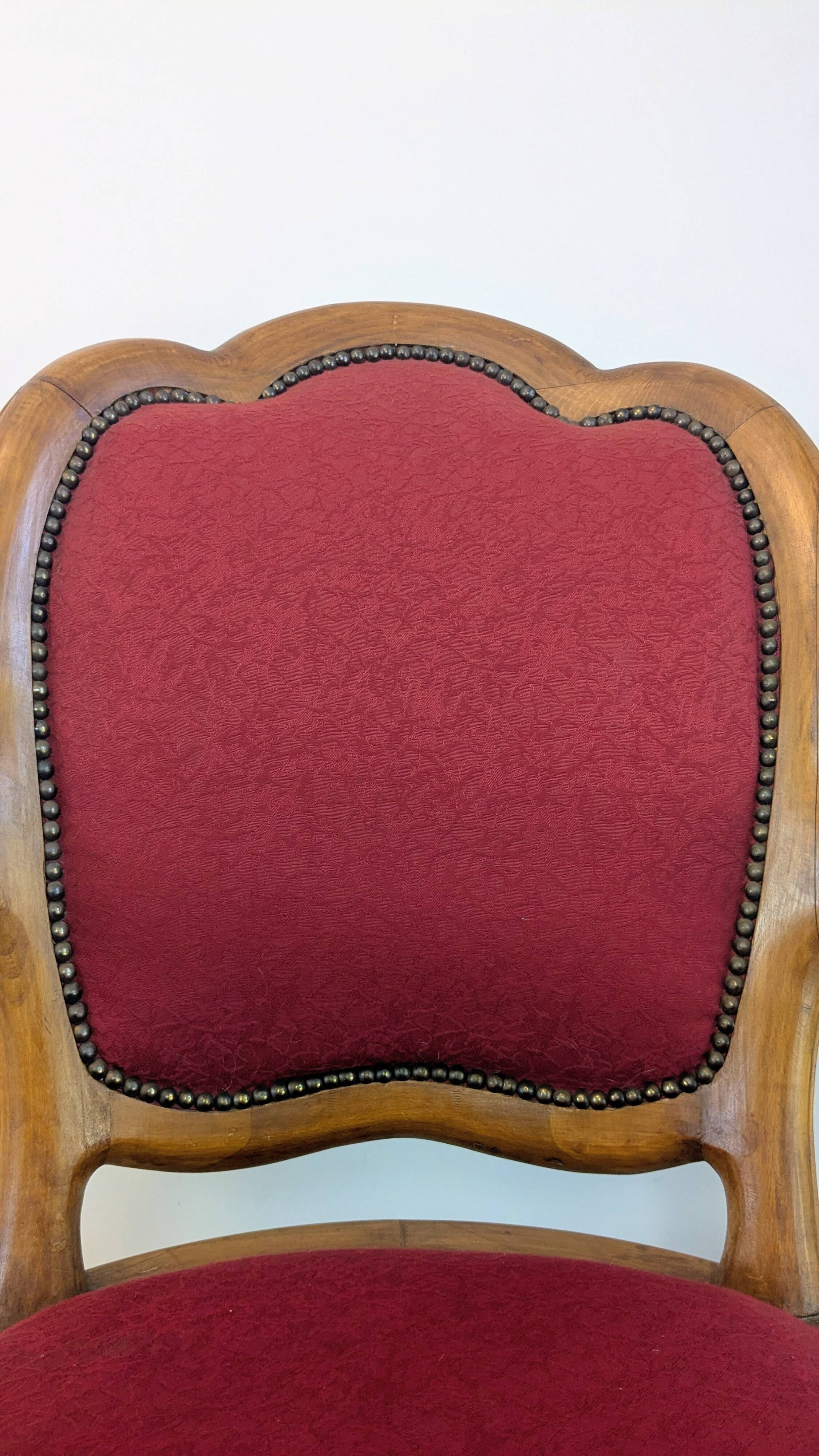 Vintage captain's chair in wood and garnet fabric — a seat with character