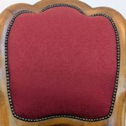 Vintage captain's chair in wood and garnet fabric — a seat with character