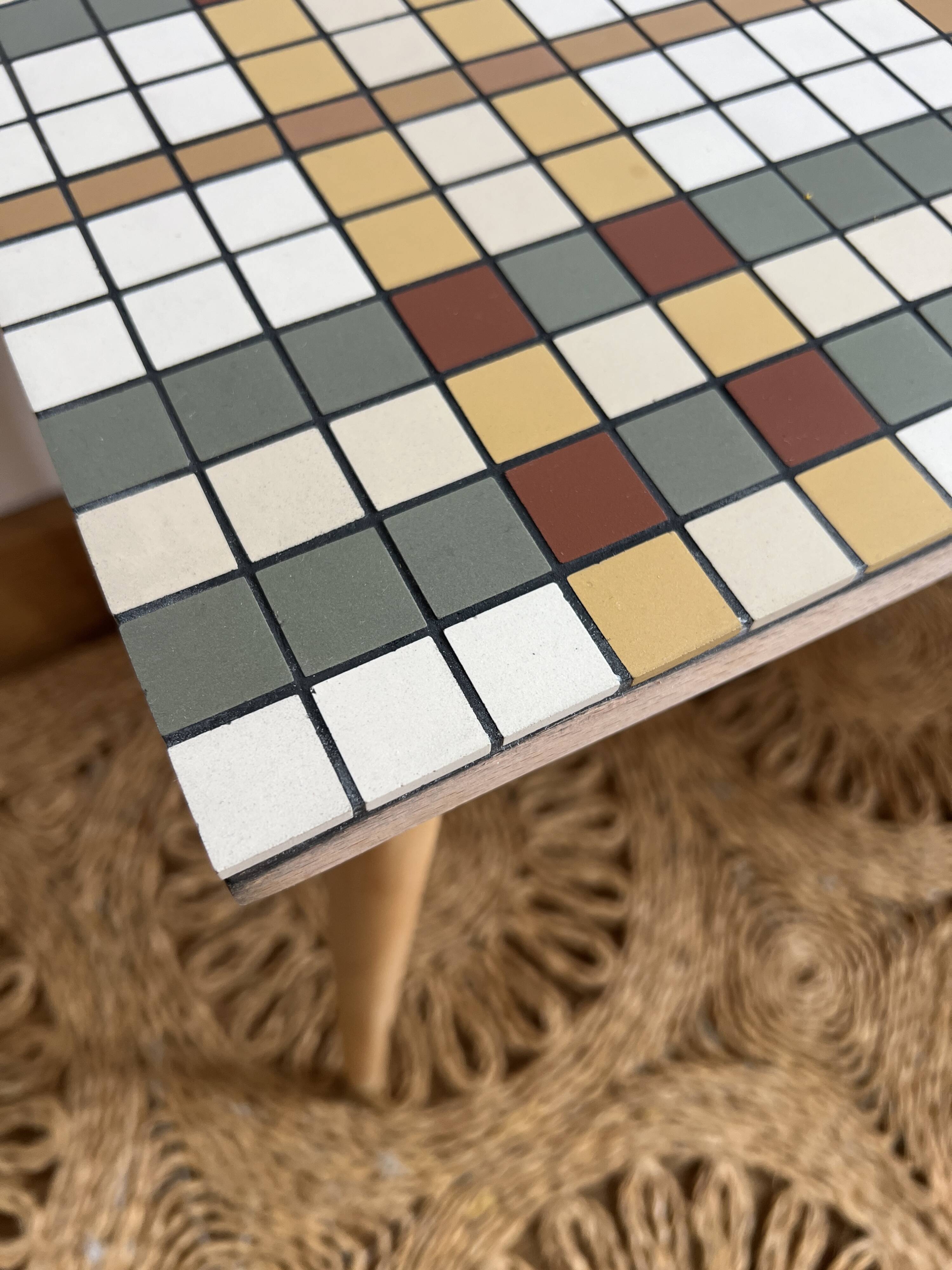 Small mosaic bedside table with tapered legs.