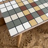 Small mosaic bedside table with tapered legs.