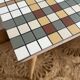 Small mosaic bedside table with tapered legs.