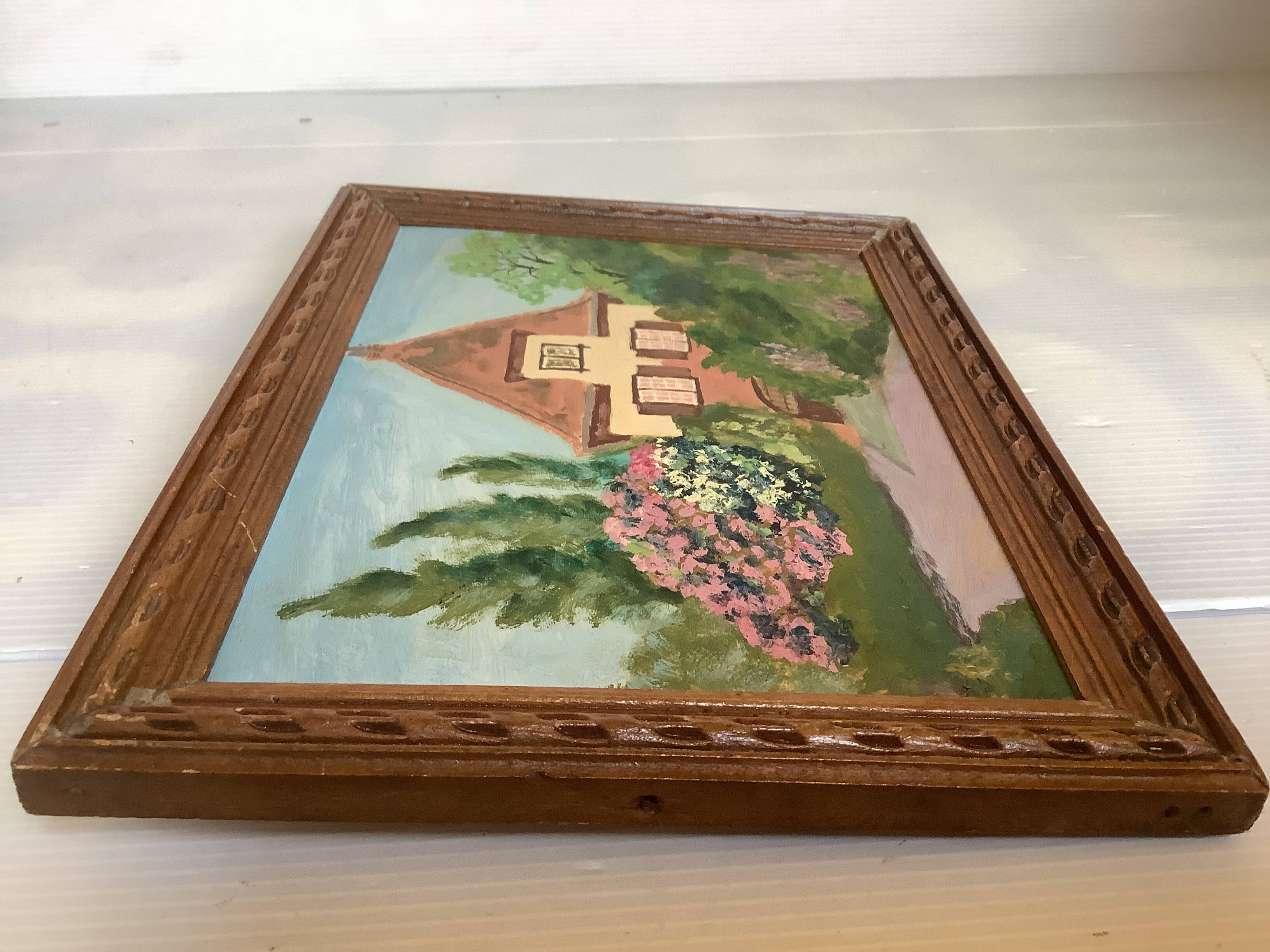 Small painting of a flowered house in oil on cardboard.
