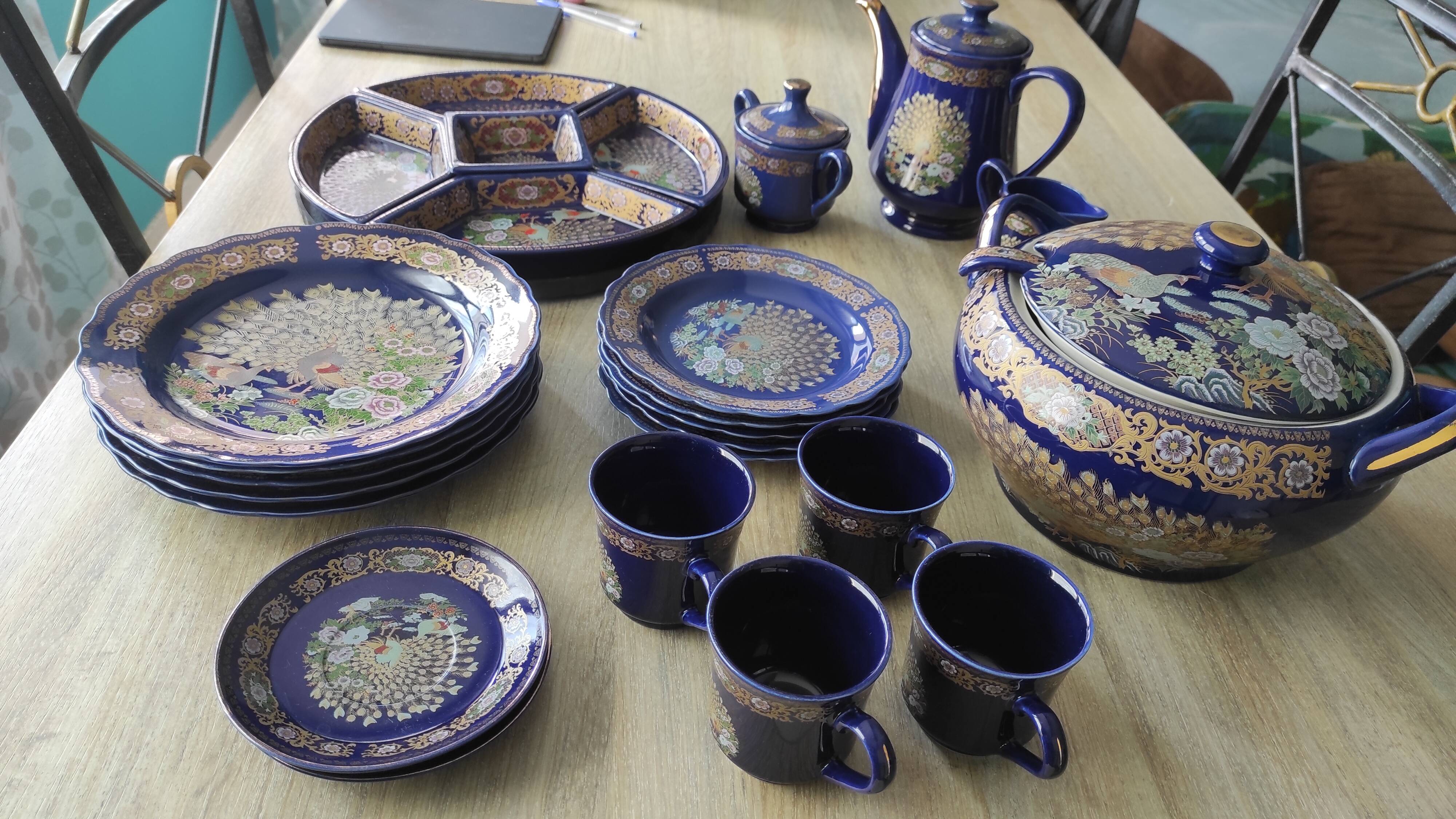 Vintage blue Taous dinnerware set of 21 pieces in very good overall condition.