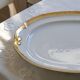 Large oval dish with gold trim in Limoges porcelain by Peconnet.