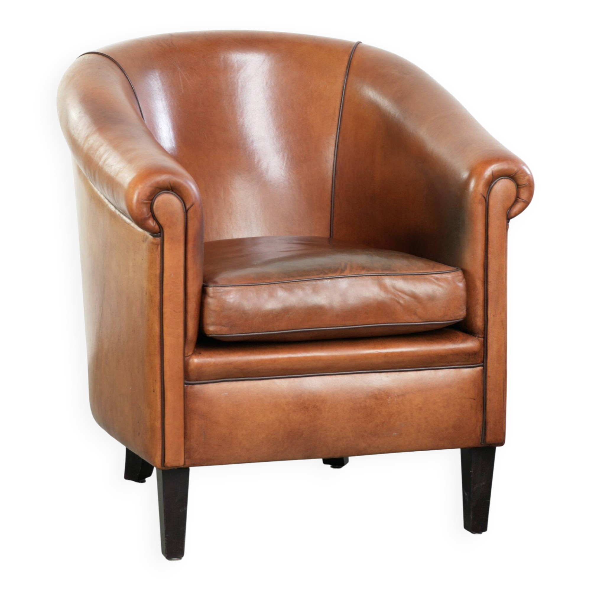 Vintage sheepskin club armchair with a warm colour scheme with black piping