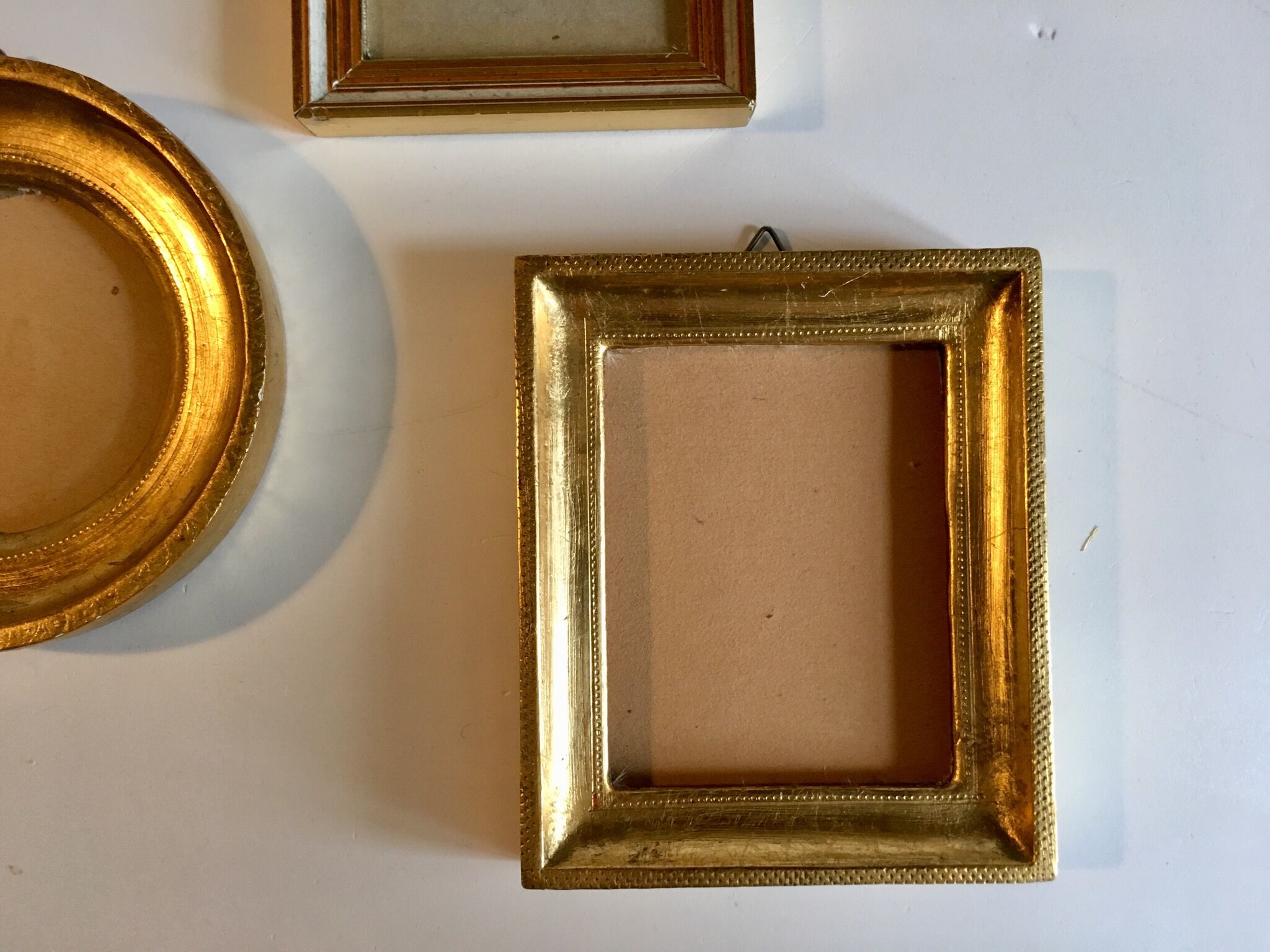 Trio of round golden wood frames and rectangles