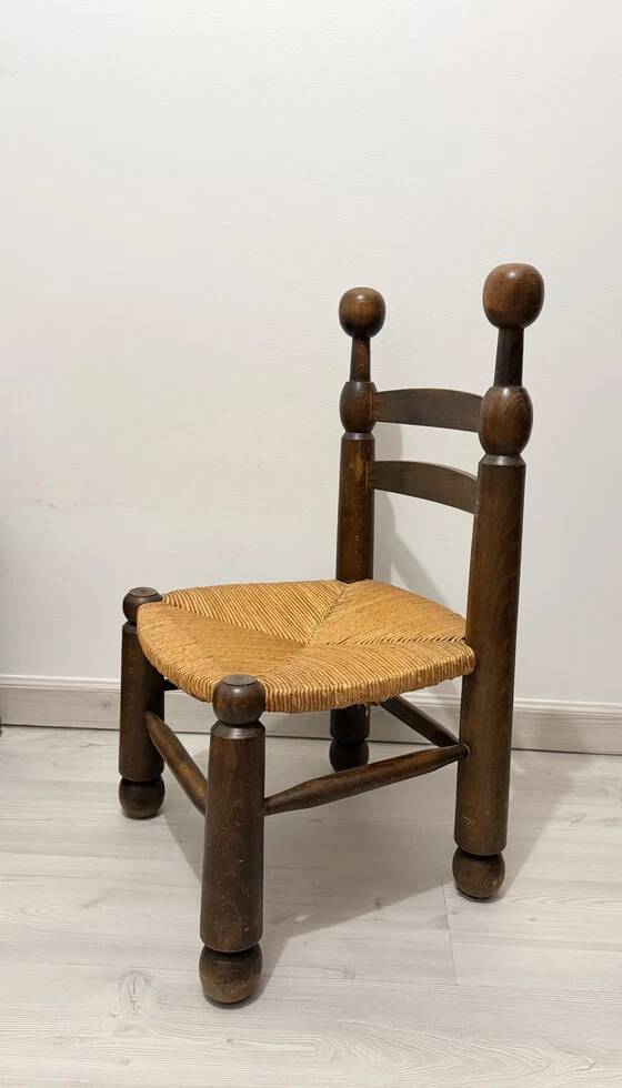 Low fireplace chair in the style of Charles Dudouyt – wood and straw seat.