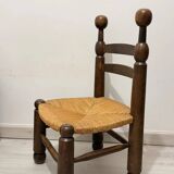 Low fireplace chair in the style of Charles Dudouyt – wood and straw seat.