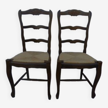 2 stylish solid wood chairs with high backs and straw seats