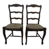 2 stylish solid wood chairs with high backs and straw seats