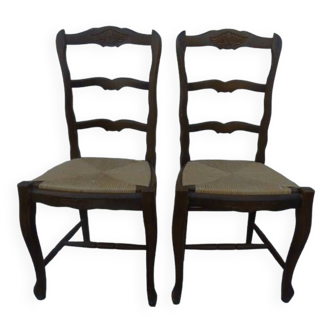 2 stylish solid wood chairs with high backs and straw seats