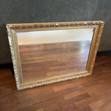 Antique mirror with a wooden and gilded stucco frame.
