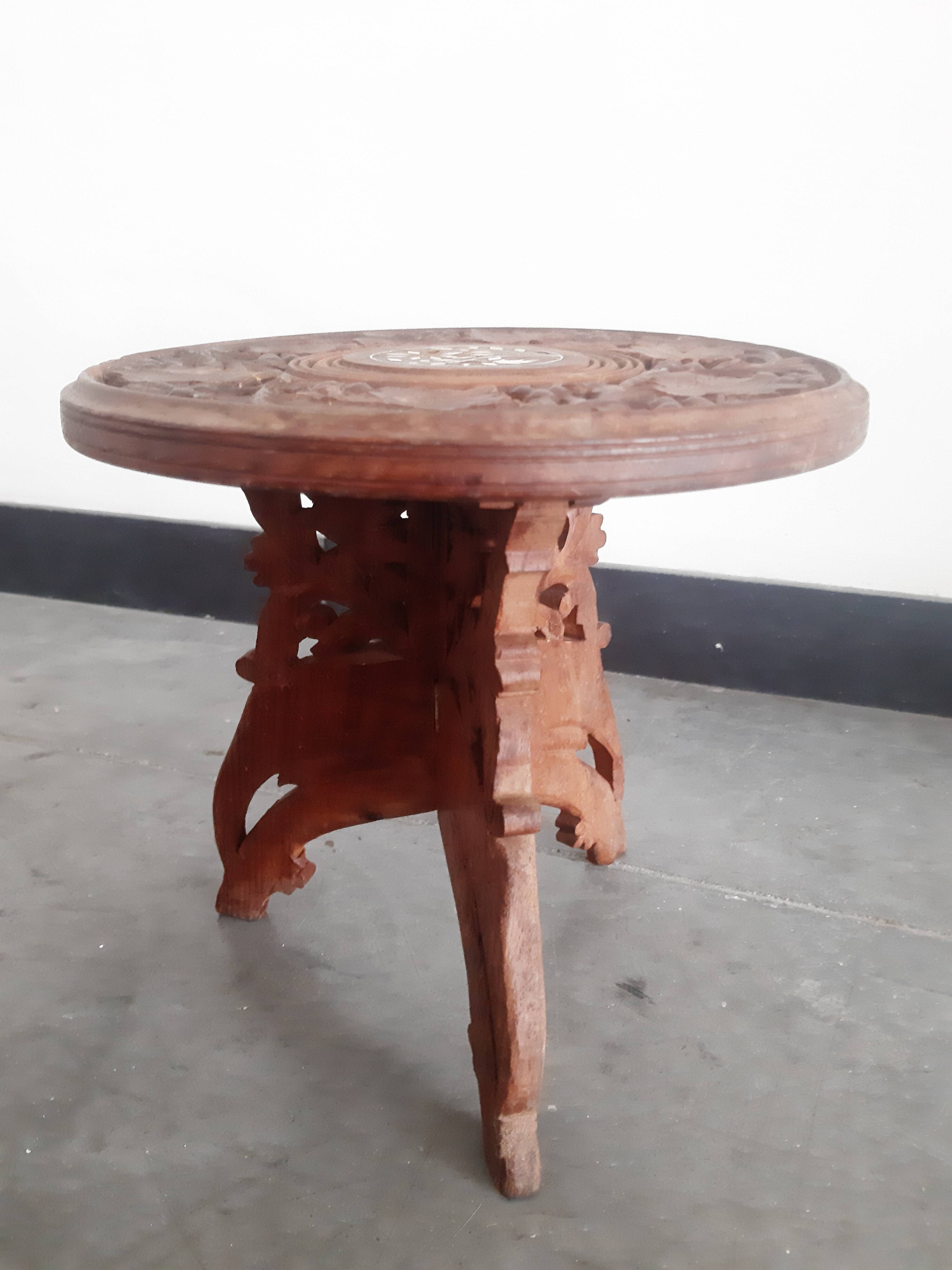 Carved wooden hunting stool decorated with vines