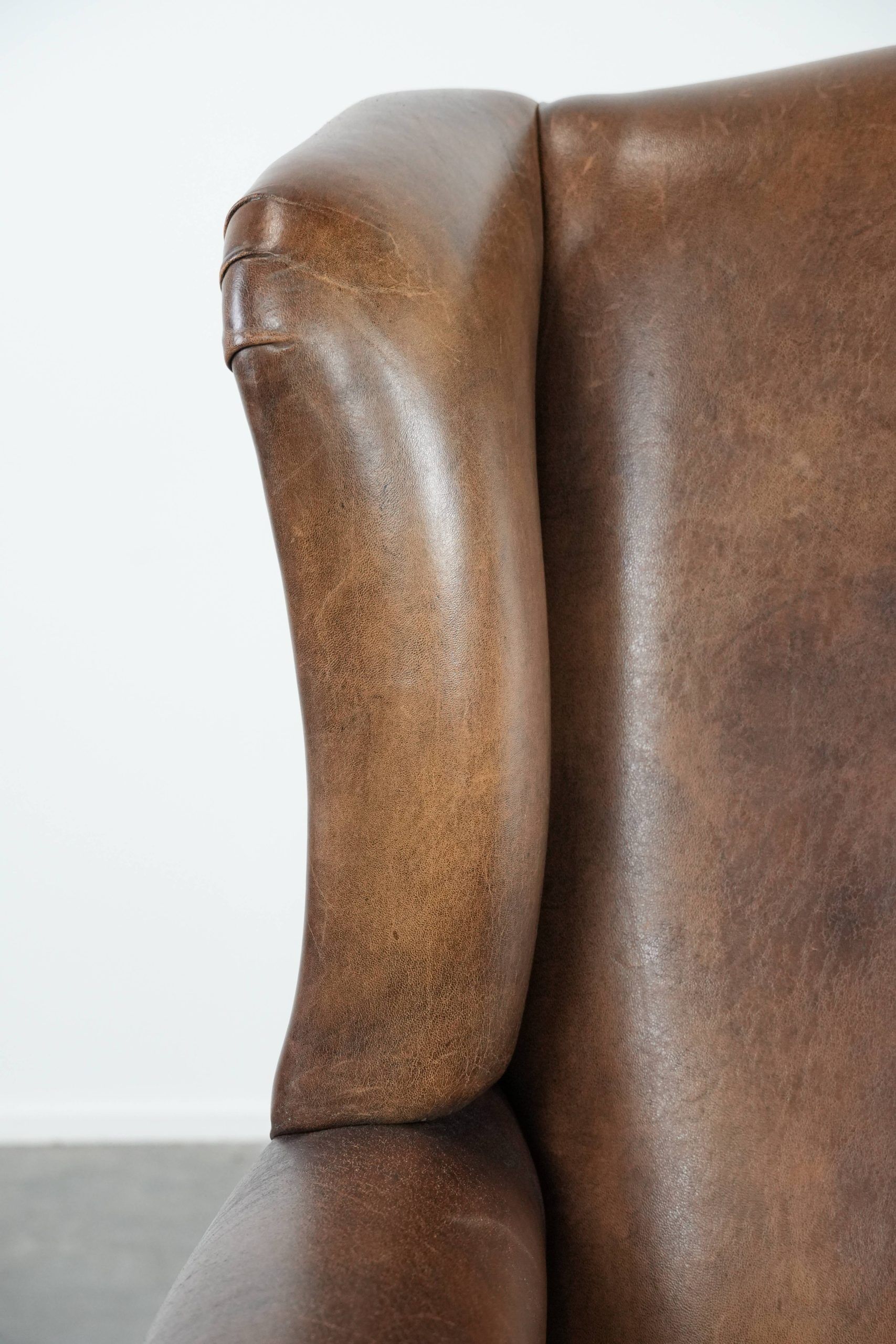 Warm, cosy and comfortable vintage sheepskin ear armchair with character