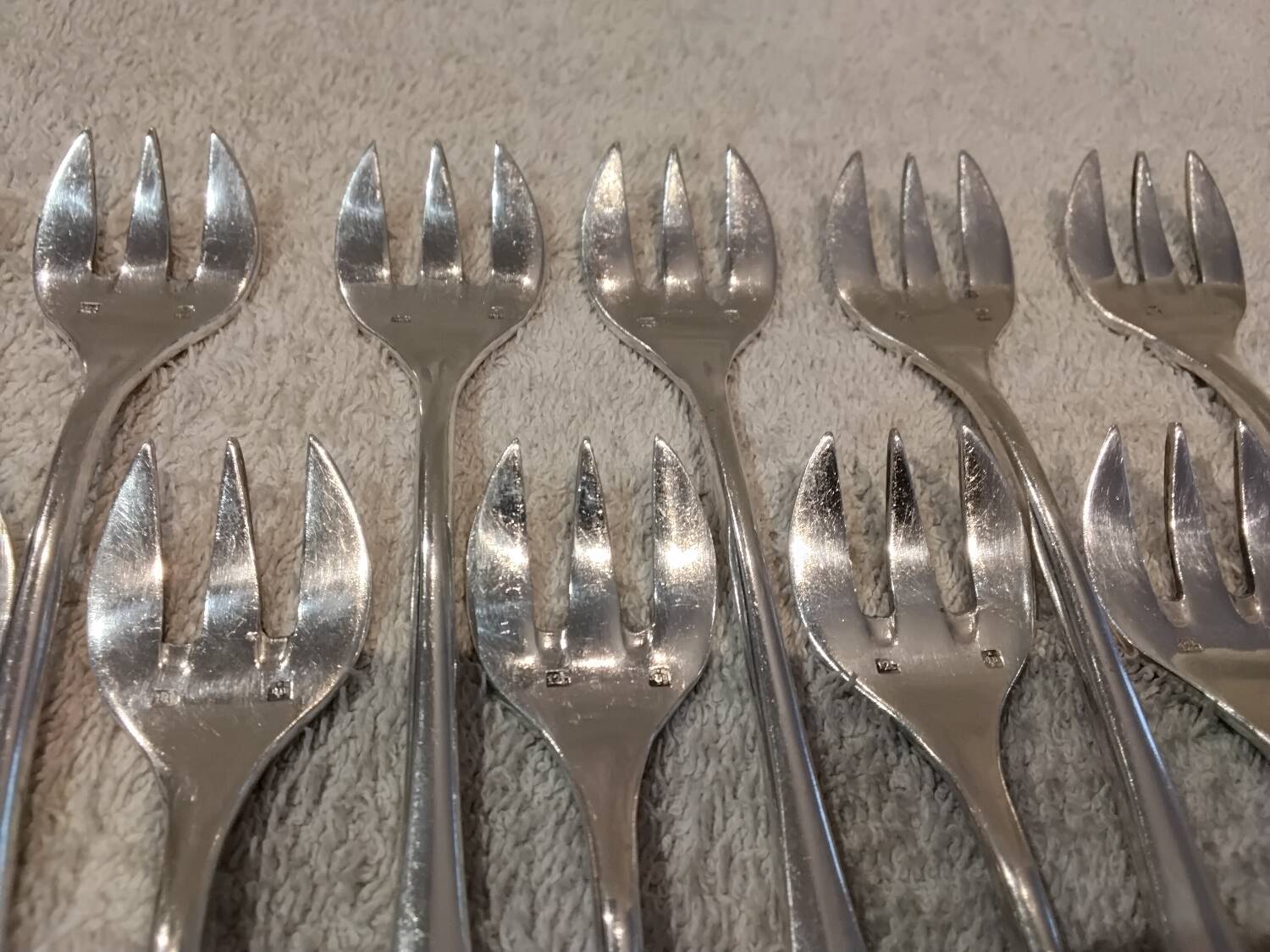12 silver-plated oyster forks by silversmith J Brille with stick handles.