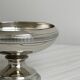 Small silver-plated metal bowl on a stand.