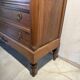 Antique carved wooden dressing table with marble and tilting oval mirror.