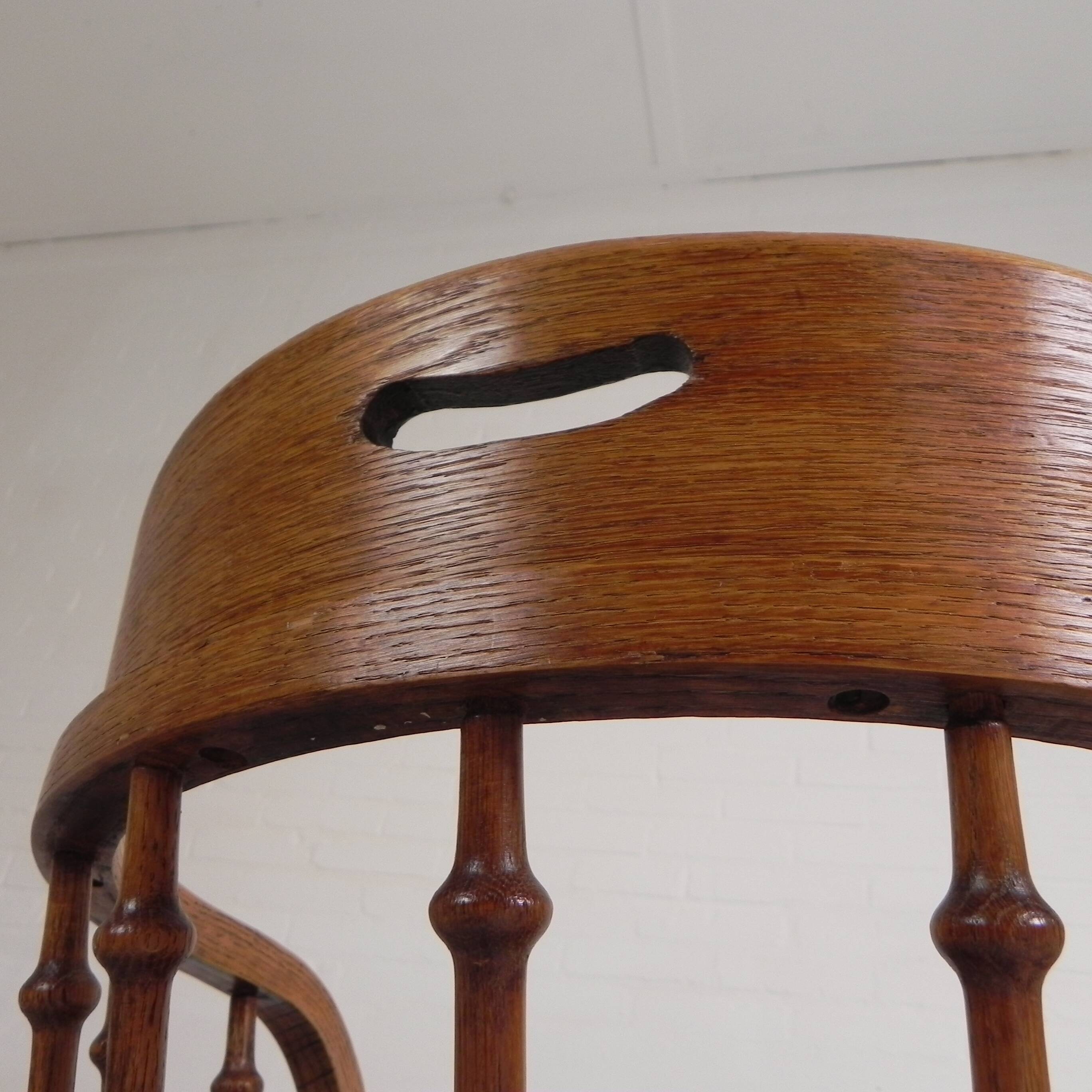 Oak office chair with a spring system and height adjustable, 1930s.