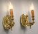 Pair of gilt bronze wall sconces in Directoire style by Lucien Gau.