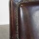 Dark brown sheepskin armchair finished with decorative nails