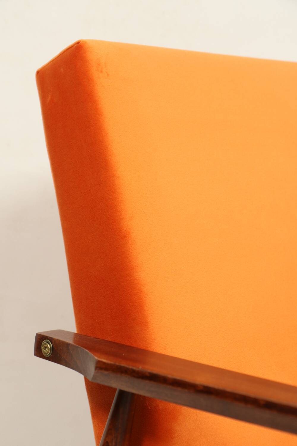Modern armchair in orange papaya velvet with dark brown wood, 1970s Scandinavian style.