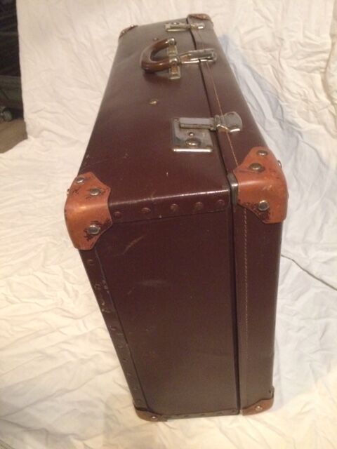 Suitcase vintage leather inside and brown carpeted home