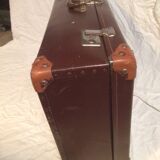 Suitcase vintage leather inside and brown carpeted home