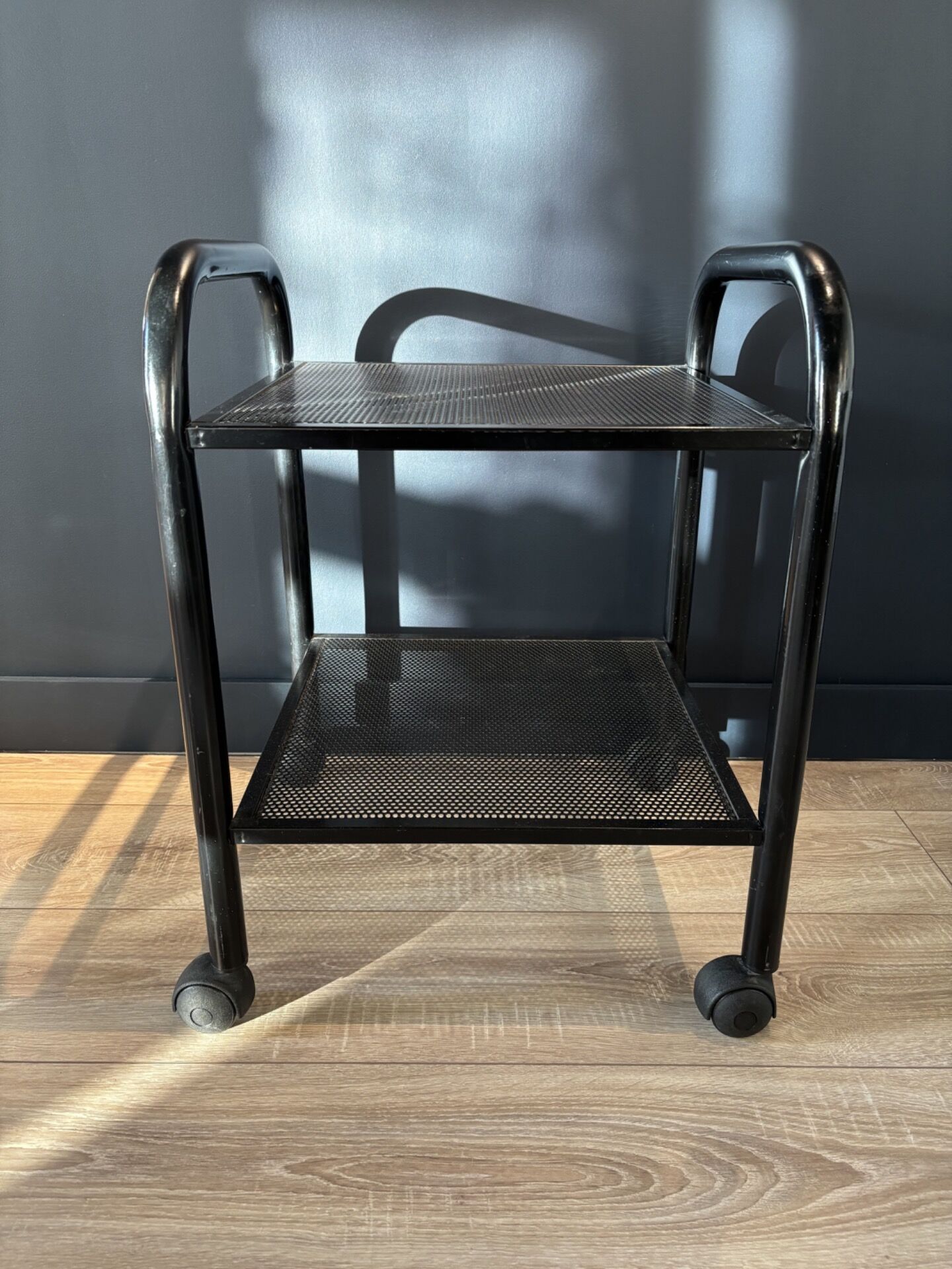 Vintage black metal rolling dessert trolley