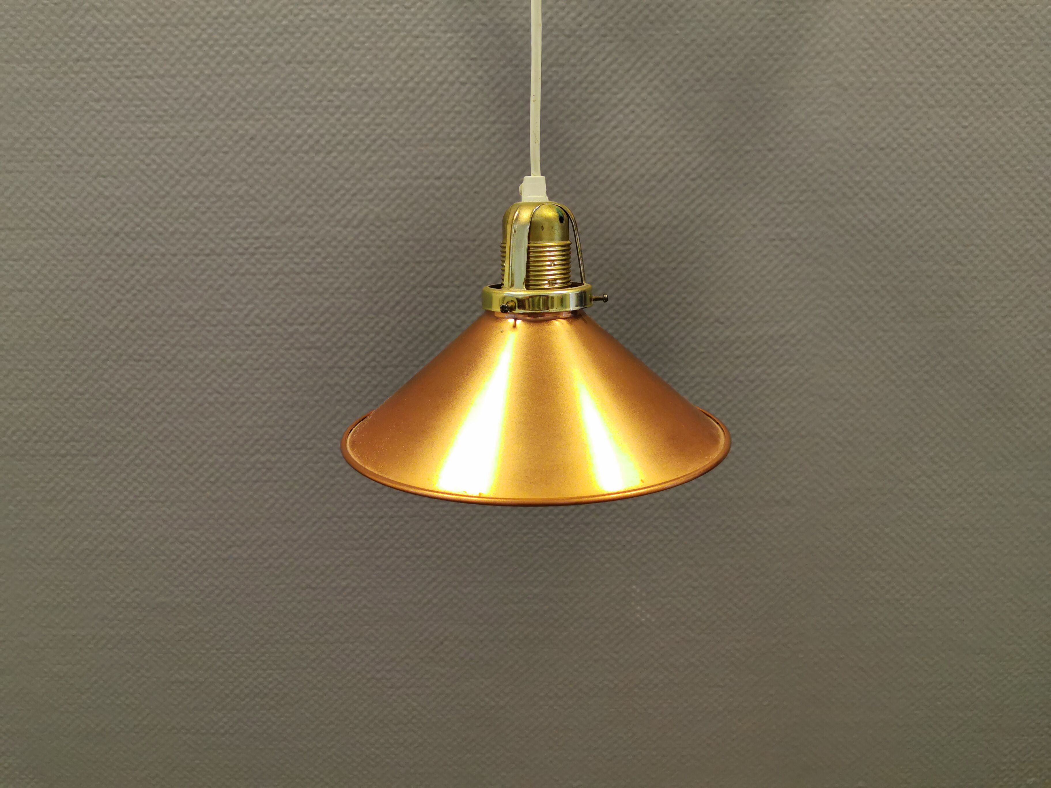 Copper hanging lamp with brass colored top and white inside lacquer.