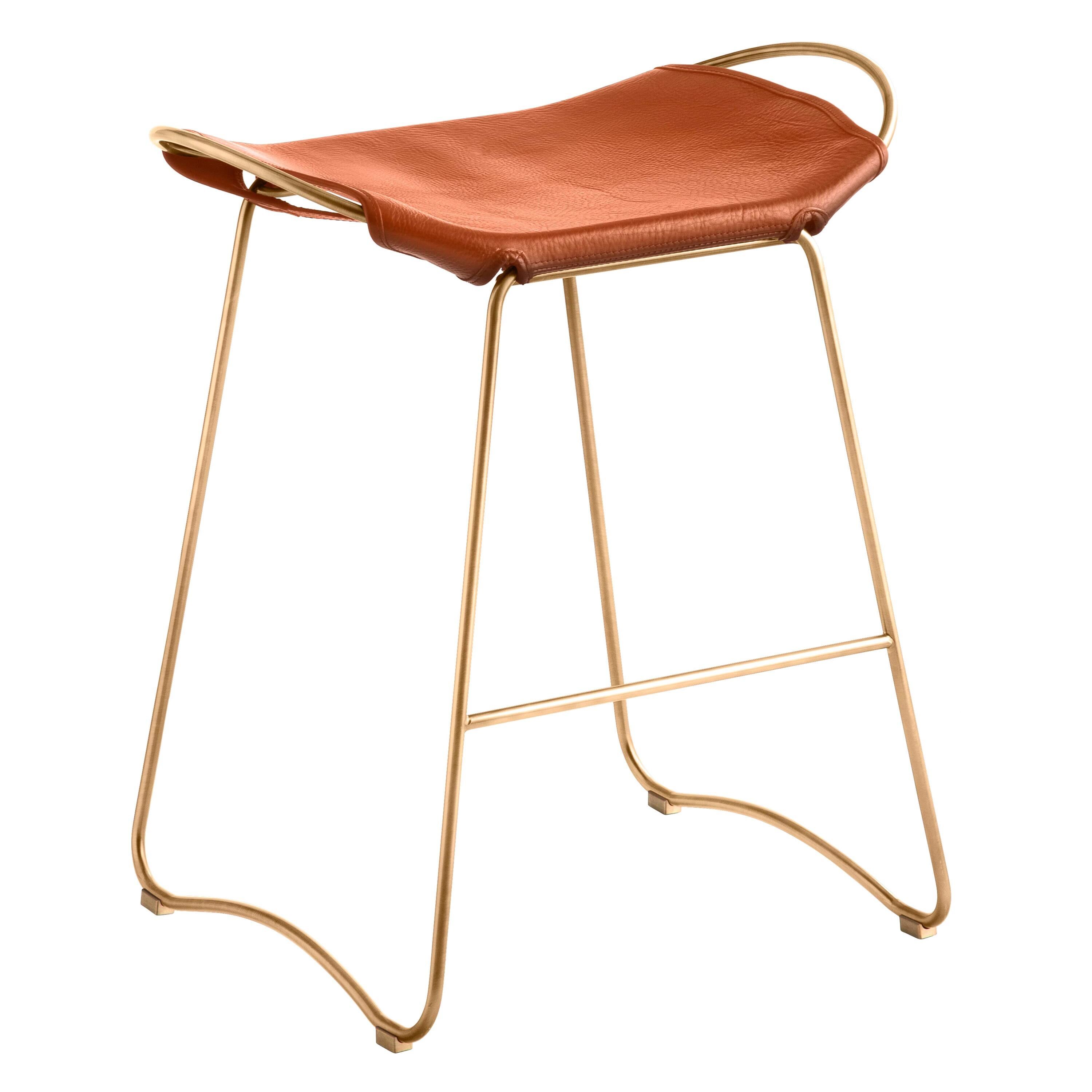 Contemporary bar stool with an organic design in aged brass metal and natural tobacco leather.
